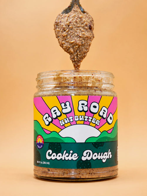 Spoonful of Cookie Dough nut butter above an open jar