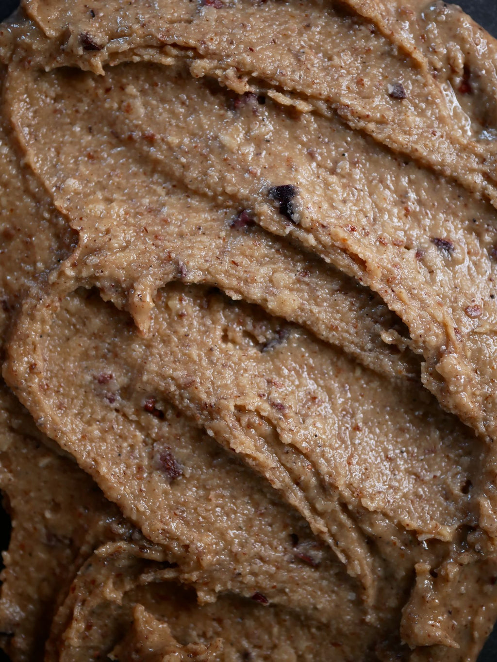 Close-up texture of Cookie Dough nut butter with cacao nibs