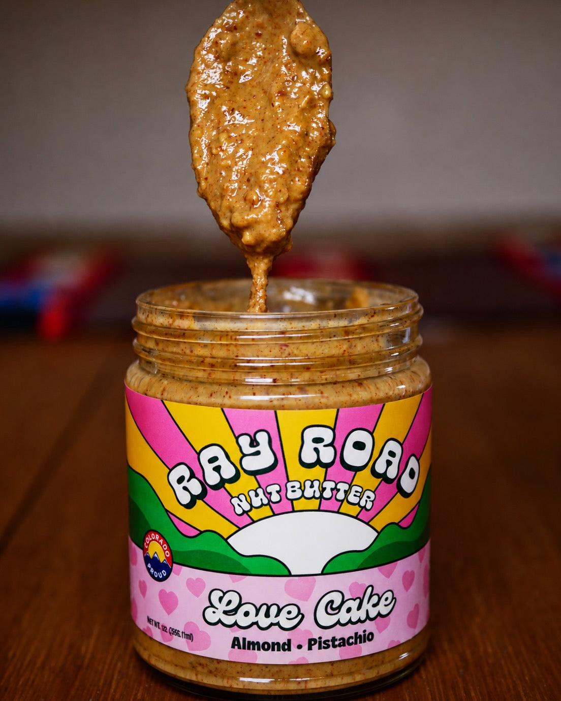 Spoonful of Love Cake nut butter above an open jar