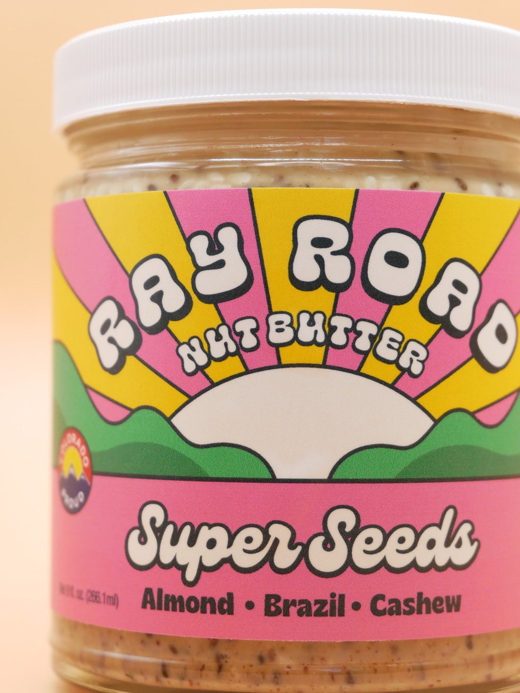 close up of super seeds jar, pink rainbow label
