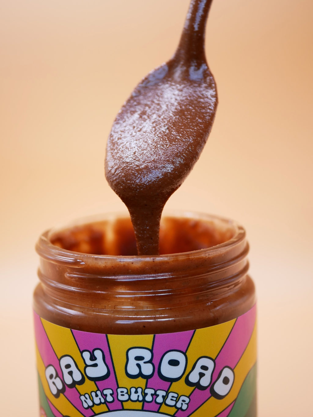 Spoonful of Ray Road Walnut Brownie nut butter dripping into the jar