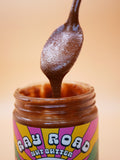 Spoonful of Ray Road Walnut Brownie nut butter dripping into the jar